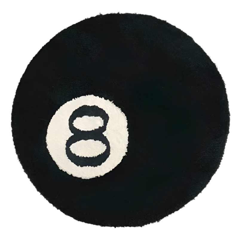 Handmade round tufted rug of a black billiards 8 ball with white circle.