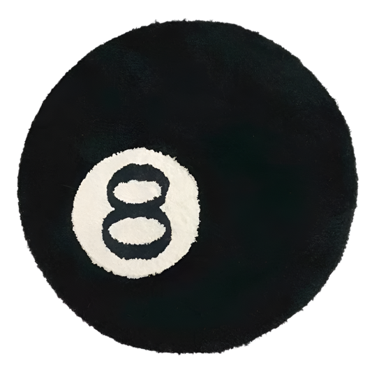 Handmade round tufted rug of a black billiards 8 ball with white circle.