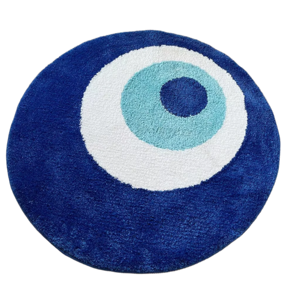 Blue and white tufted rug shaped like an evil eye symbol for protection.