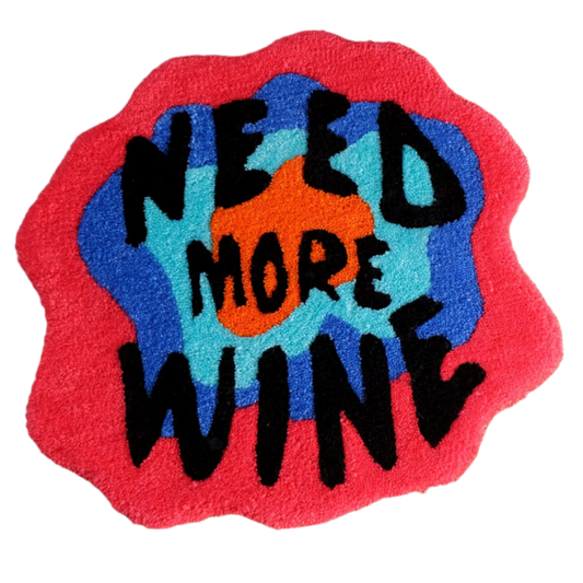 Tufted text rug reading "Need More Wine" in bold playful font.