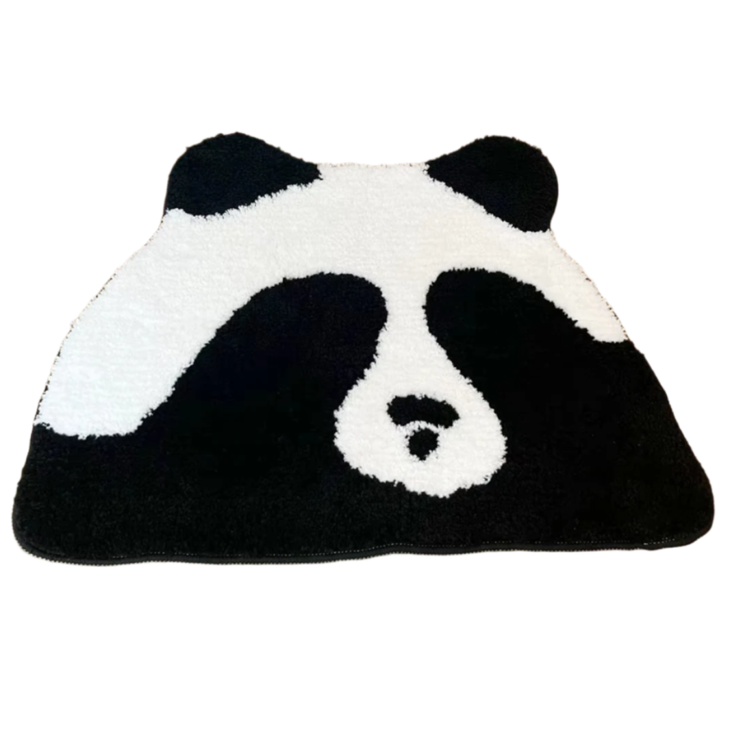 Cartoon panda covering its eyes on a soft tufted rug.