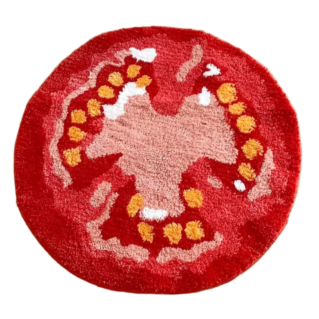 Tufted tomato-shaped rug in deep red with inner detail.