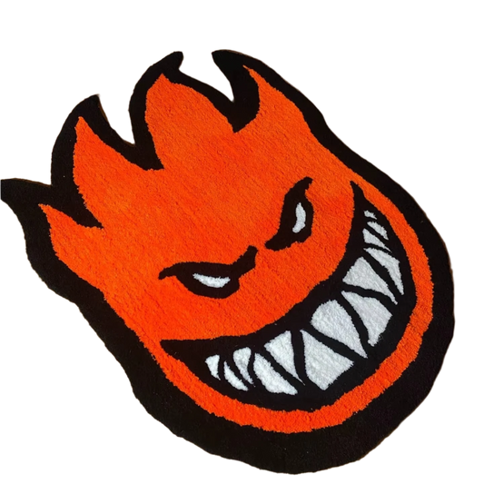 Spitfire flame face logo rug in bright orange, black, and white.