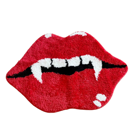 Red lips with sharp vampire fangs on a glossy, plush tufted rug.